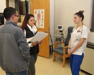 nurse speaking to two students